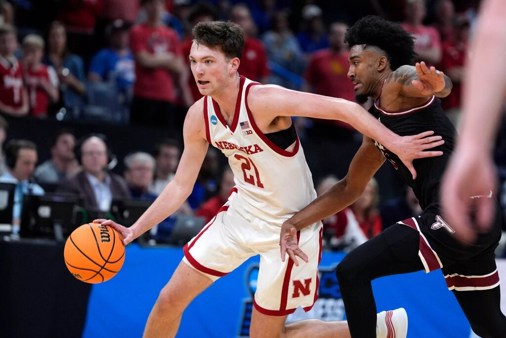 Nebraska Cornhuskers forward Pryce Sandfort (21) dribbles past Troy Trojans forward Jerrell Bellamy (10) during a first-round game in the NCAA men's basketball tournament between Nebraska and Troy at Paycom Center in Oklahoma City, Thursday, March 19, 2026.