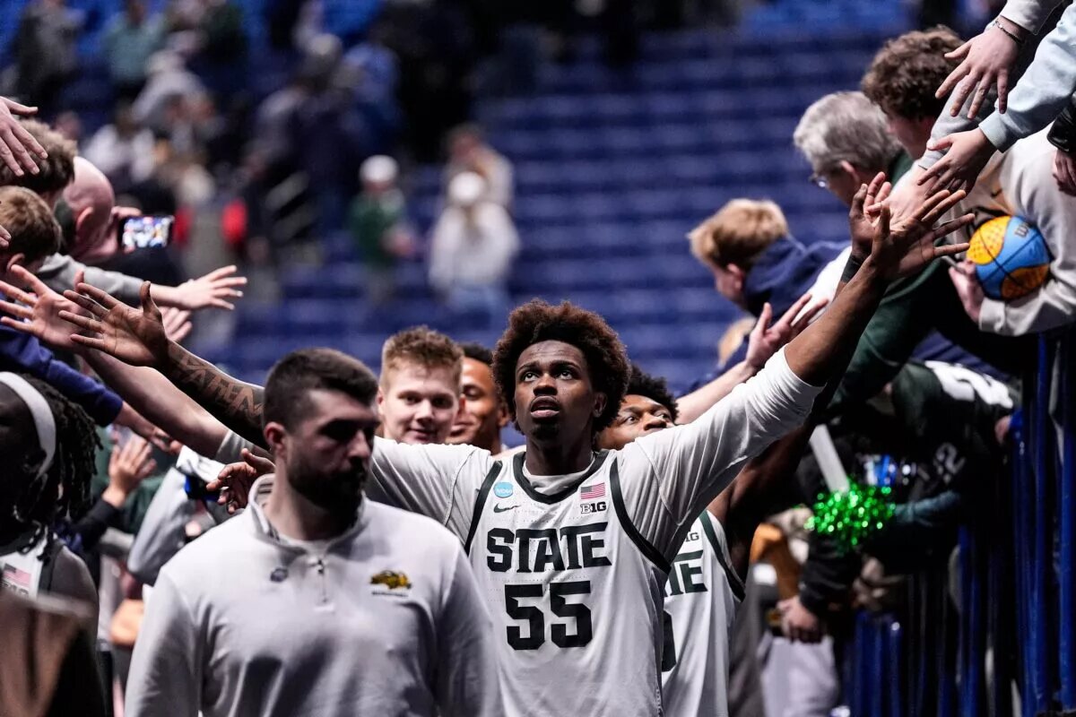 Michigan State forward Coen Carr (55) high fives fans after 92-67 win over North Dakota State at the NCAA Tournament First Round at KeyBank Center in Buffalo on Thursday, March 19, 2026.