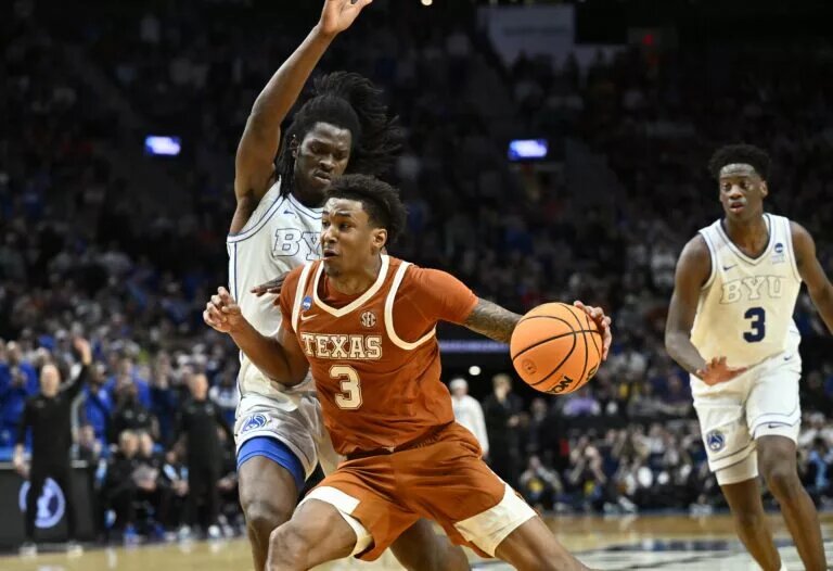 Mar 19, 2026; Portland, OR, USA; Texas Longhorns forward Dailyn Swain (3) drives against BYU Cougars forward Khadim Mboup (7) in the second half during a first round game of the men's 2026 NCAA Tournament at Moda Center. Mandatory Credit: Craig Strobeck-Imagn Images