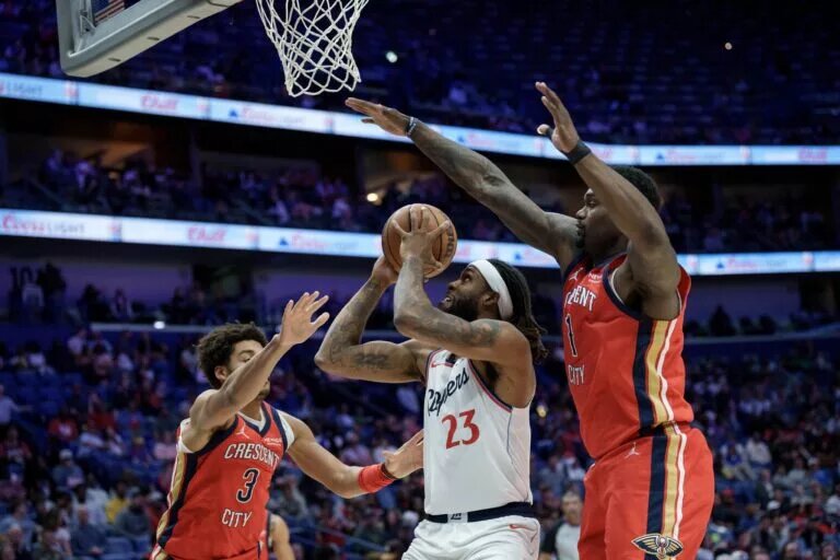 Mar 19, 2026; New Orleans, Louisiana, USA; LA Clippers forward Isaiah Jackson (23) shoots against New Orleans Pelicans guard Jordan Poole (3) and forward Zion Williamson (1) during the second half at Smoothie King Center. Mandatory Credit: Matthew Hinton-Imagn Images