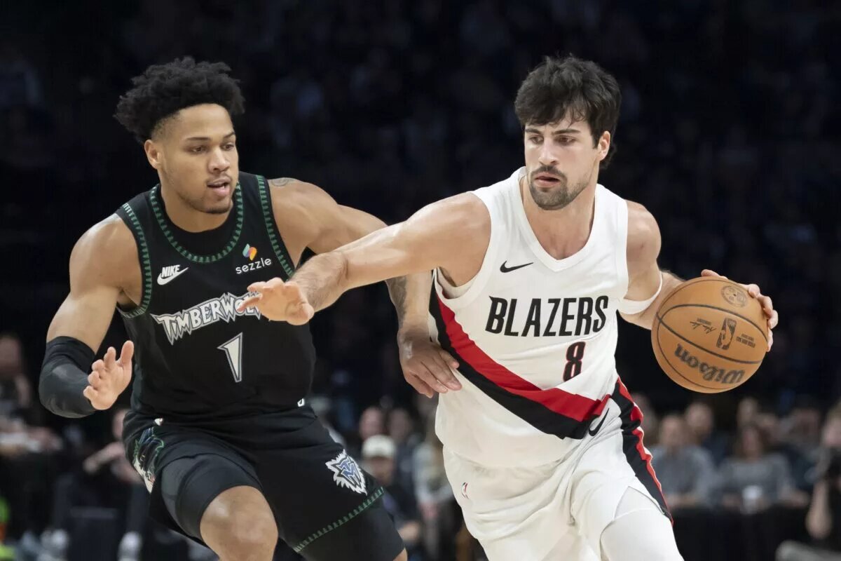 Portland Trail Blazers forward Deni Avdija (8) dribbles the ball as Minnesota Timberwolves guard Terrence Shannon Jr. (1) plays defense in the first half at Target Center.