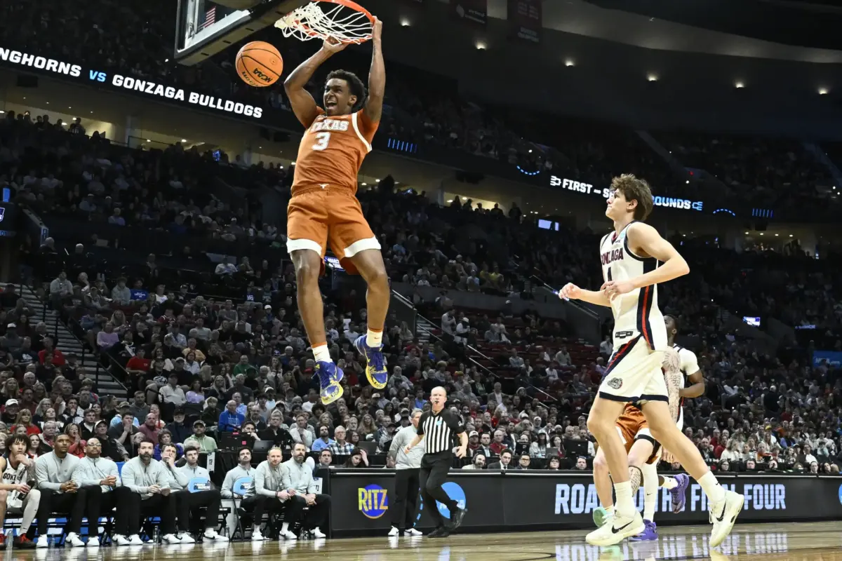 Mar 21, 2026; Portland, OR, USA; Texas Longhorns forward Dailyn Swain (3) dunks against Gonzaga Bulldogs guard Davis Fogle (4) in the first half during a second round game of the men's 2026 NCAA Tournament at Moda Center. Mandatory Credit: Craig Strobeck-Imagn Images