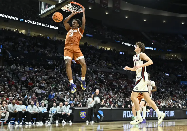 Mar 21, 2026; Portland, OR, USA; Texas Longhorns forward Dailyn Swain (3) dunks against Gonzaga Bulldogs guard Davis Fogle (4) in the first half during a second round game of the men's 2026 NCAA Tournament at Moda Center. Mandatory Credit: Craig Strobeck-Imagn Images