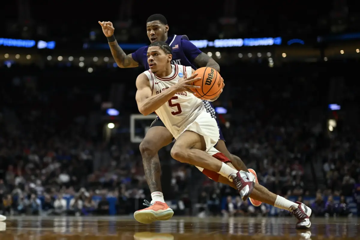 Arkansas Razorbacks guard Darius Acuff Jr. (5) drives against High Point Panthers forward Cam'ron Fletcher (11) in the second half during a second round game of the men's 2026 NCAA Tournament at Moda Center.