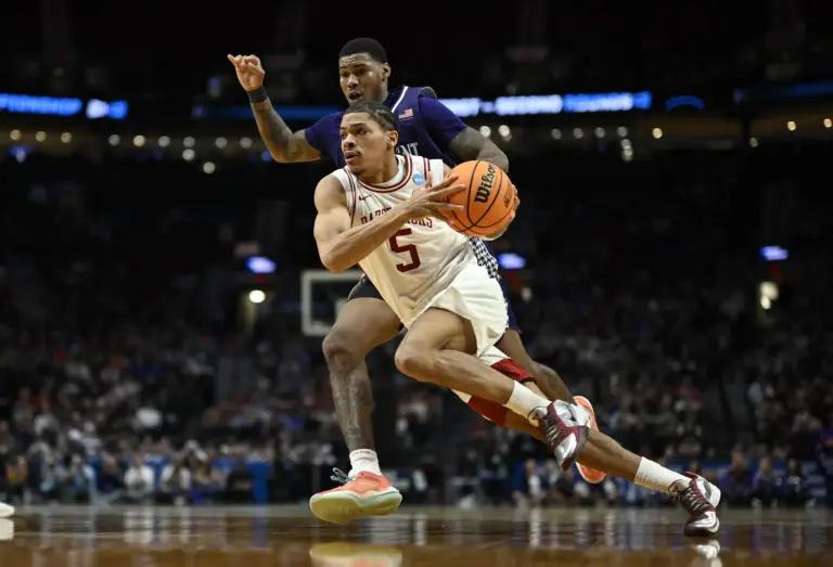 Arkansas Razorbacks guard Darius Acuff Jr. (5) drives against High Point Panthers forward Cam'ron Fletcher (11) in the second half during a second round game of the men's 2026 NCAA Tournament at Moda Center.