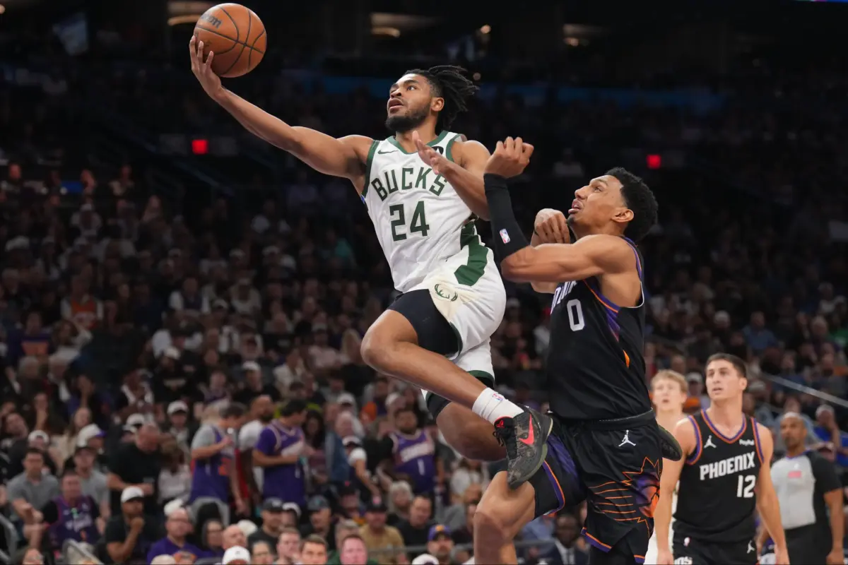 Mar 21, 2026; Phoenix, Arizona, USA; Milwaukee Bucks guard Cam Thomas (24) goes up for a layup against Phoenix Suns forward Ryan Dunn (0) during the second half at Mortgage Matchup Center. Mandatory Credit: Joe Camporeale-Imagn Images