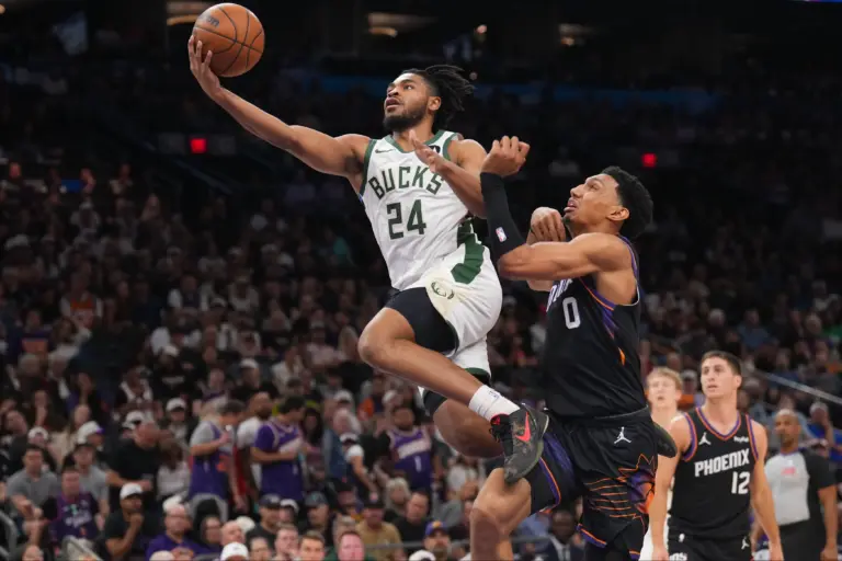 Mar 21, 2026; Phoenix, Arizona, USA; Milwaukee Bucks guard Cam Thomas (24) goes up for a layup against Phoenix Suns forward Ryan Dunn (0) during the second half at Mortgage Matchup Center. Mandatory Credit: Joe Camporeale-Imagn Images