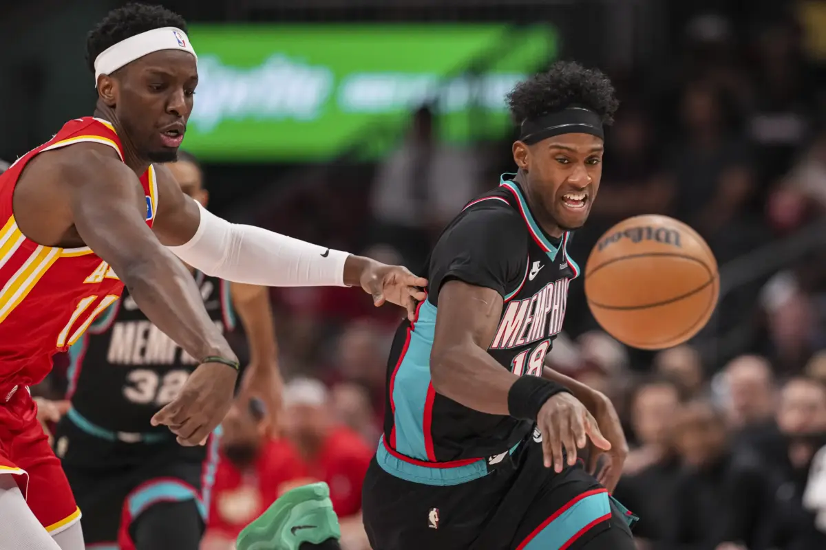 Mar 23, 2026; Atlanta, Georgia, USA; Memphis Grizzlies forward Olivier-Maxence Prosper (18) steals the ball from Atlanta Hawks forward Onyeka Okongwu (17) during the first half at State Farm Arena. Mandatory Credit: Dale Zanine-Imagn Images