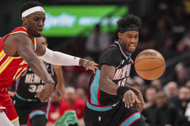 Mar 23, 2026; Atlanta, Georgia, USA; Memphis Grizzlies forward Olivier-Maxence Prosper (18) steals the ball from Atlanta Hawks forward Onyeka Okongwu (17) during the first half at State Farm Arena. Mandatory Credit: Dale Zanine-Imagn Images