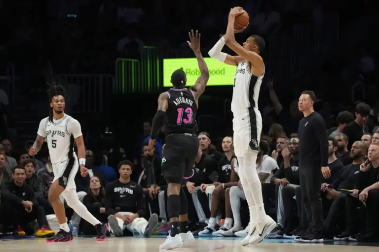 Mar 23, 2026; Miami, Florida, USA; San Antonio Spurs forward Victor Wembanyama (1) shoots over Miami Heat center Bam Adebayo (13) during the first half at Kaseya Center. Mandatory Credit: Jim Rassol-Imagn Images