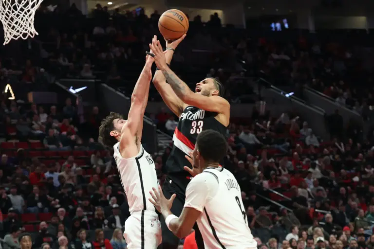 Mar 23, 2026; Portland, Oregon, USA; Portland Trail Blazers forward Toumani Camara (33) shoots the ball over Brooklyn Nets guard Ben Saraf (77) during the first half at Moda Center. Mandatory Credit: Jaime Valdez-Imagn Images