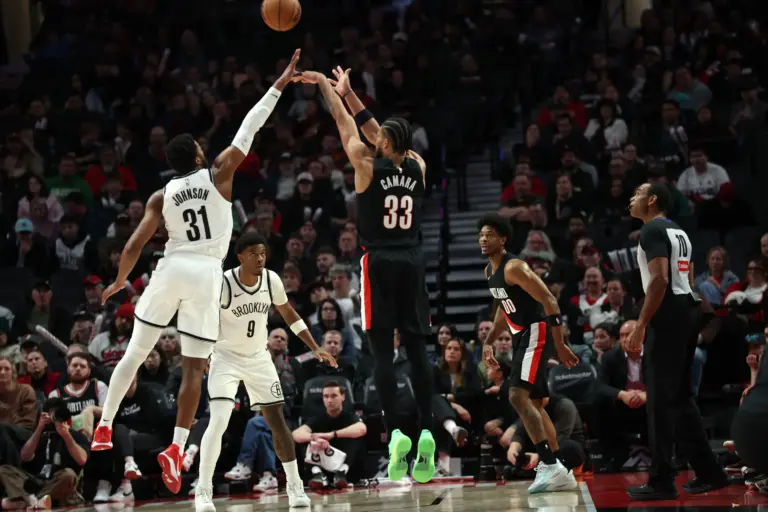 Mar 23, 2026; Portland, Oregon, USA; Portland Trail Blazers forward Toumani Camara (33) shoots the ball over Brooklyn Nets guard/forward Chaney Johnson (31) during the second half at Moda Center. Mandatory Credit: Jaime Valdez-Imagn Images