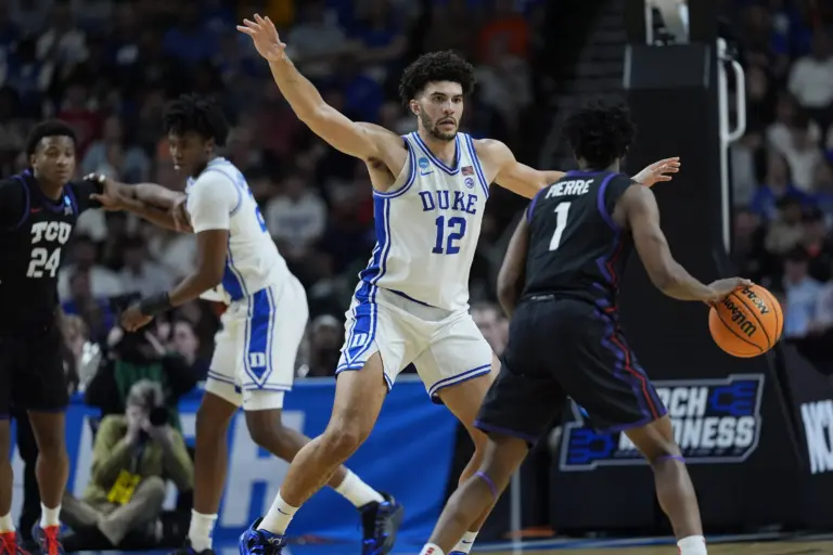 Duke Blue Devils forward Cameron Boozer (12) defends against Texas Christian University Horned Frogs guard Jayden Pierre (1) during a second round game of the men's 2026 NCAA Tournament at Bon Secours Wellness Arena.