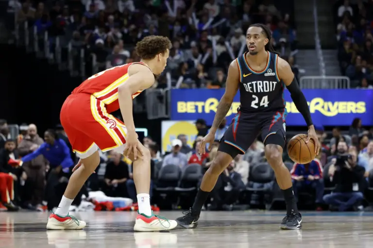 Detroit Pistons guard Daniss Jenkins (24) dribbles defended by Atlanta Hawks guard Dyson Daniels (5) in the first half at Little Caesars Arena.
