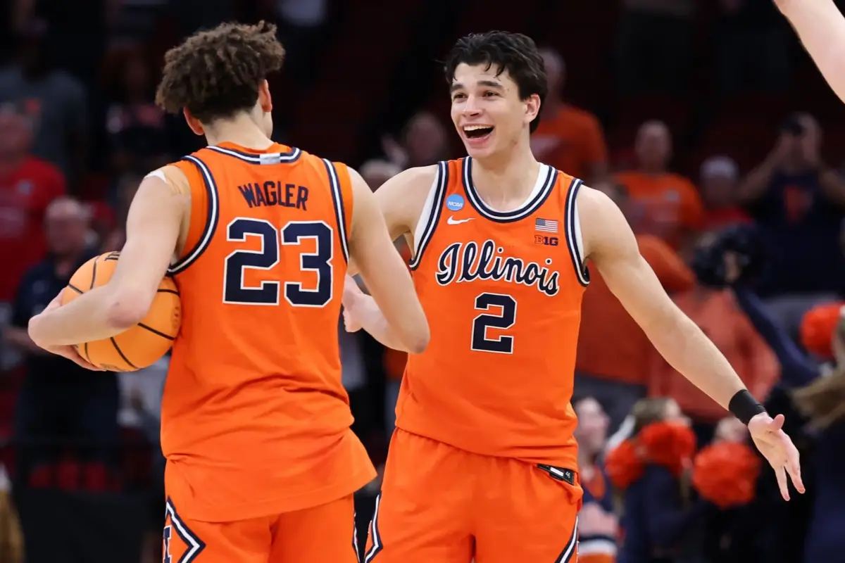 Illinois Fighting Illini guard Keaton Wagler (23) and guard Andrej Stojakovic (2) reacts after the game in a Sweet Sixteen game of the South Regional of the men's 2026 NCAA Tournament at Toyota Center.