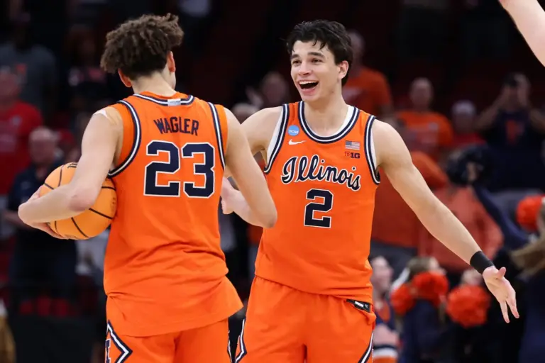 Illinois Fighting Illini guard Keaton Wagler (23) and guard Andrej Stojakovic (2) reacts after the game in a Sweet Sixteen game of the South Regional of the men's 2026 NCAA Tournament at Toyota Center.