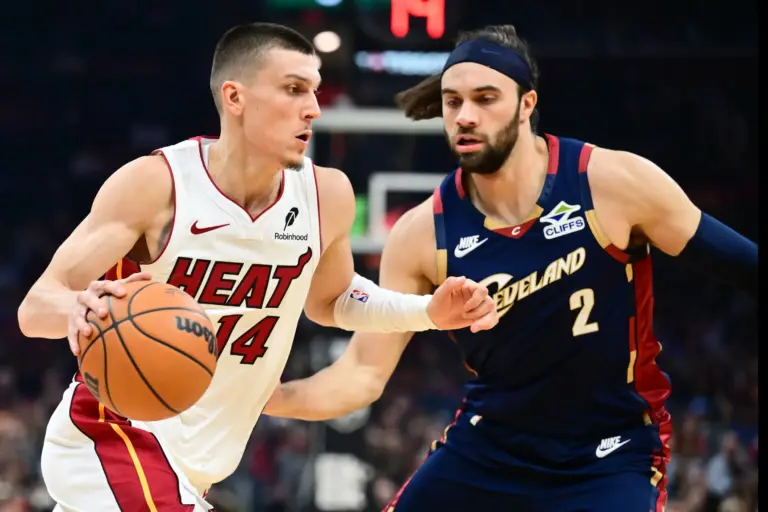 Mar 27, 2026; Cleveland, Ohio, USA; Miami Heat guard Tyler Herro (14) drives to the basket against Cleveland Cavaliers guard Max Strus (2) during the first half at Rocket Arena. Mandatory Credit: Ken Blaze-Imagn Images