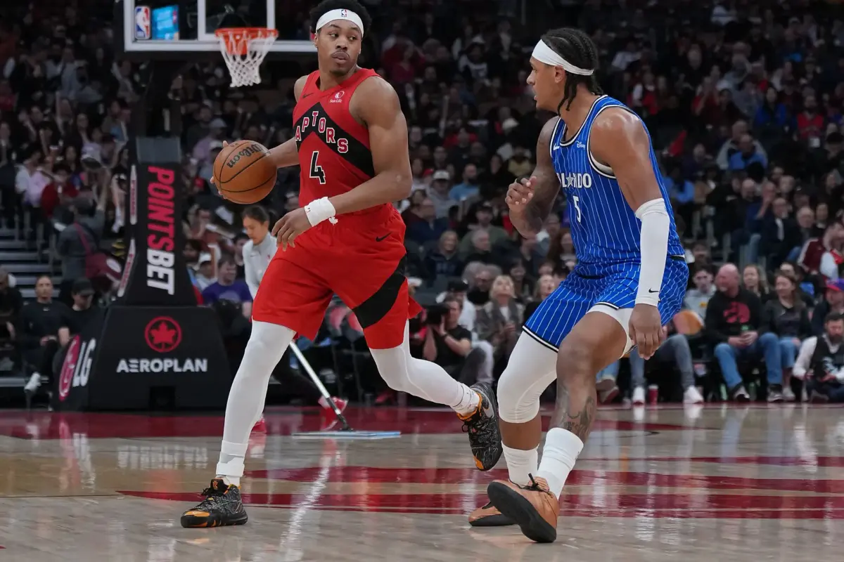 Toronto Raptors forward Scottie Barnes (4) controls the ball as Orlando Magic forward Paolo Banchero (5) tries to defend during the third quarter at Scotiabank Arena.