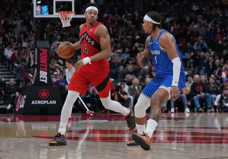 Toronto Raptors forward Scottie Barnes (4) controls the ball as Orlando Magic forward Paolo Banchero (5) tries to defend during the third quarter at Scotiabank Arena.