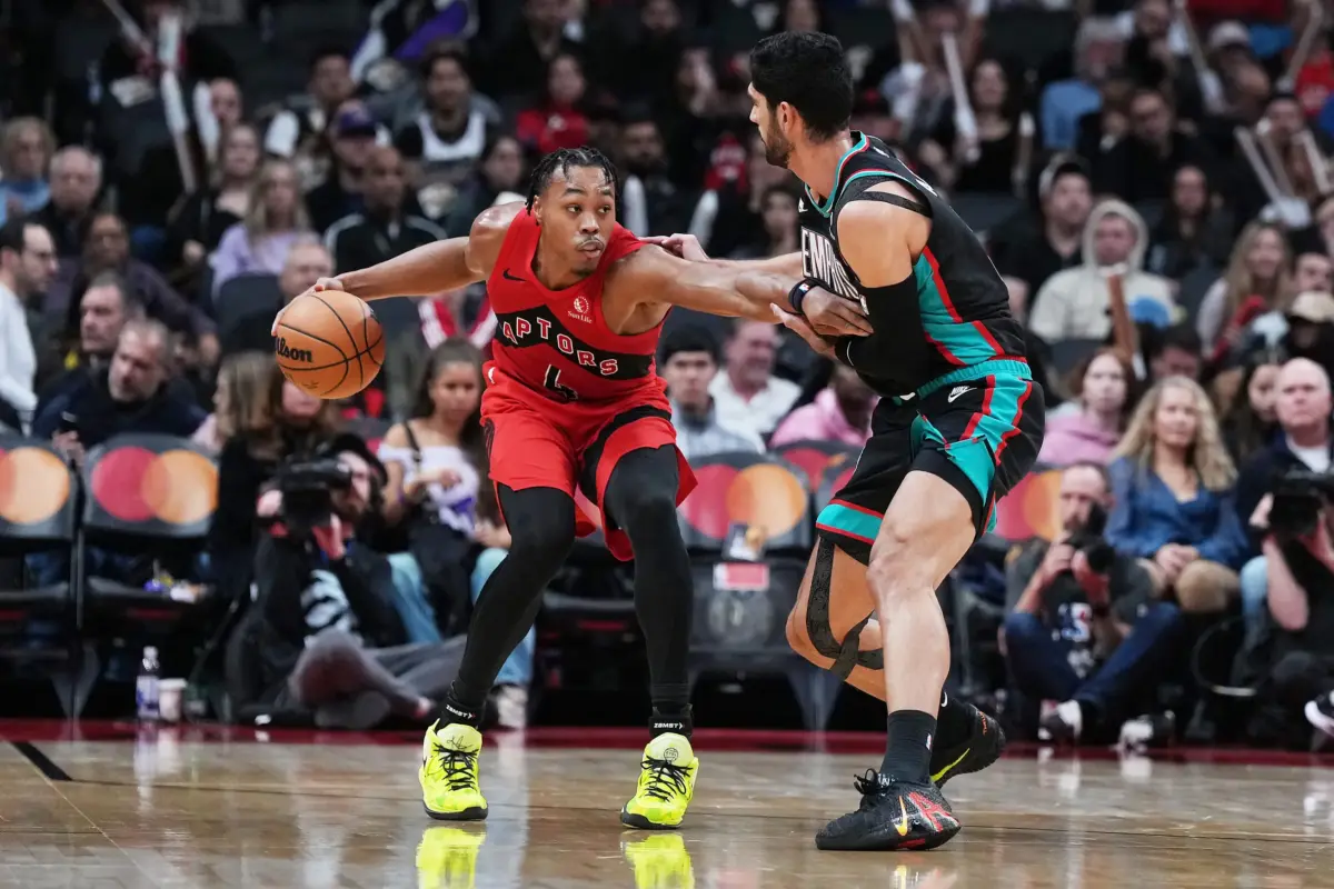 Nov 2, 2025; Toronto, Ontario, CAN; Toronto Raptors forward Scottie Barnes (4) controls the ball as Memphis Grizzlies forward Santi Aldama (7) tries to defend during the fourth quarter at Scotiabank Arena. Mandatory Credit: Nick Turchiaro-Imagn Images