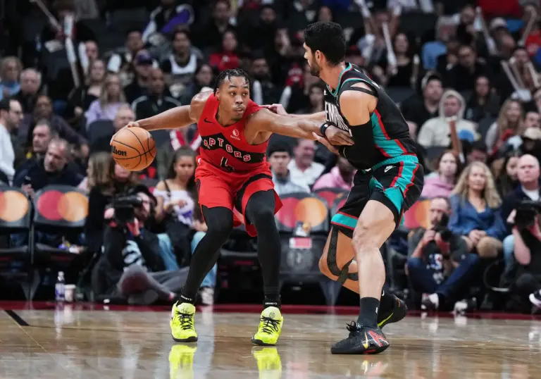 Nov 2, 2025; Toronto, Ontario, CAN; Toronto Raptors forward Scottie Barnes (4) controls the ball as Memphis Grizzlies forward Santi Aldama (7) tries to defend during the fourth quarter at Scotiabank Arena. Mandatory Credit: Nick Turchiaro-Imagn Images
