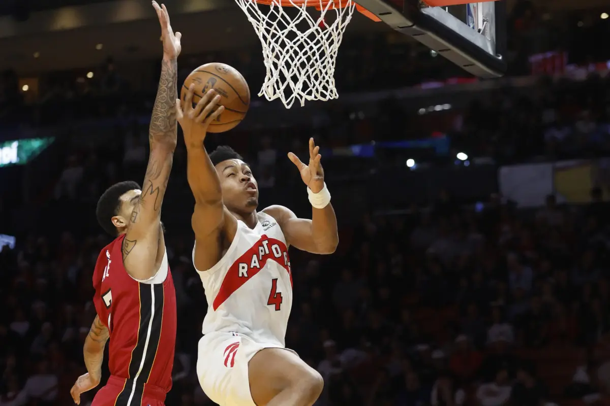 Dec 23, 2025; Miami, Florida, USA; Miami Heat center Kel'El Ware (7) defends Toronto Raptors forward Scottie Barnes (4) during the first half at Kaseya Center. Mandatory Credit: Rhona Wise-Imagn Images