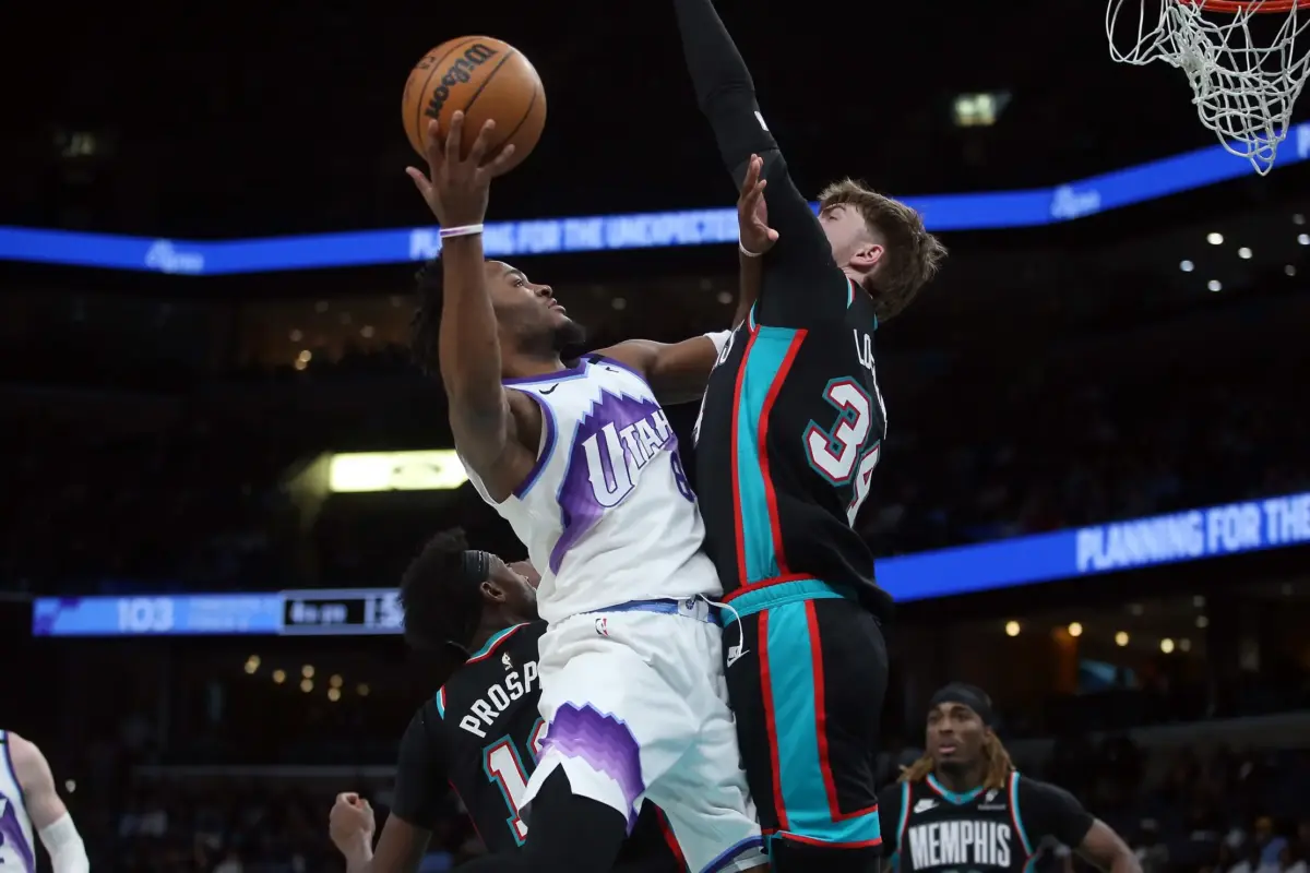 Feb 20, 2026; Memphis, Tennessee, USA; Utah Jazz guard Isaiah Collier (8) shoots against Memphis Grizzlies center Lawson Lovering (34) during the fourth quarter at FedExForum. Mandatory Credit: Petre Thomas-Imagn Images