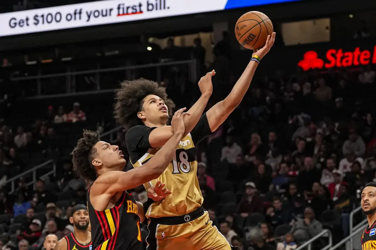 Feb 24, 2026; Atlanta, Georgia, USA; Washington Wizards forward Kyshawn George (18) goes to the basket over Atlanta Hawks forward Jalen Johnson (1) during the first half at State Farm Arena. Mandatory Credit: Dale Zanine-Imagn Images