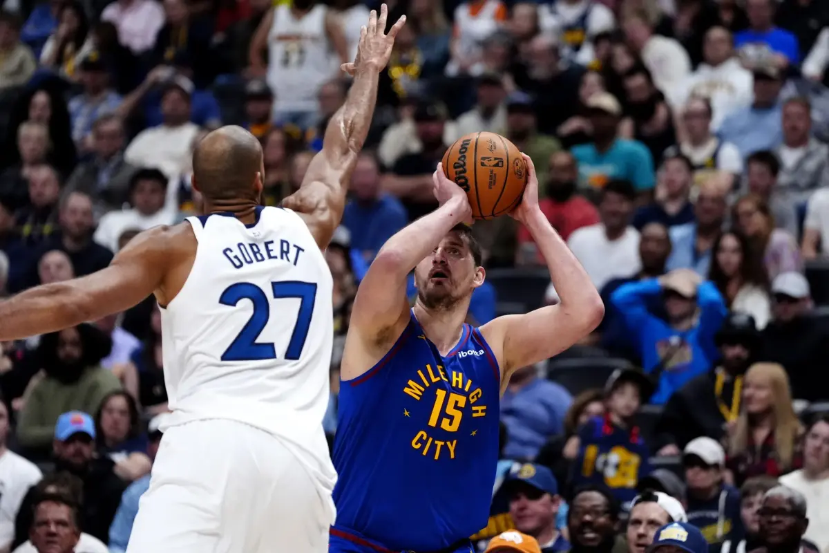 Minnesota Timberwolves center Rudy Gobert (27) defends on Denver Nuggets center Nikola Jokic (15) in the second half at Ball Arena.