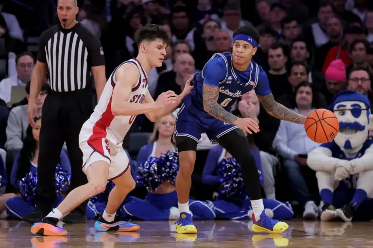Mar 13, 2026; New York, NY, USA; Seton Hall Pirates guard Adam Clark (0) controls the ball against St. John's Red Storm guard Dylan Darling (0) during the second half at Madison Square Garden. Mandatory Credit: Brad Penner-Imagn Images