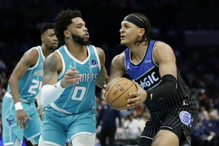 Mar 19, 2026; Charlotte, North Carolina, USA; Orlando Magic forward Paolo Banchero (5) tries to drive to the basket past Charlotte Hornets forward Miles Bridges (0) during the third quarter at Spectrum Center. Mandatory Credit: Brian Westerholt-Imagn Images