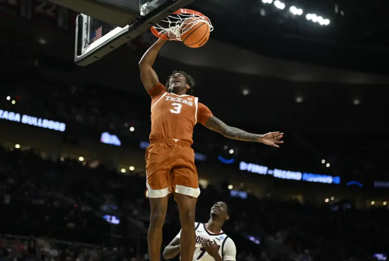 Texas Longhorns forward Dailyn Swain (3) dunks against Gonzaga Bulldogs guard Tyon Grant-Foster (7) in the second half during a second round game of the men's 2026 NCAA Tournament at Moda Center.
