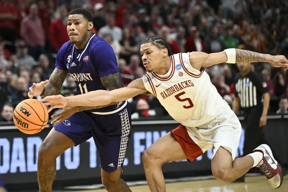 Mar 21, 2026; Portland, OR, USA; Arkansas Razorbacks guard Darius Acuff Jr. (5) defends High Point Panthers forward Cam'ron Fletcher (11) in the second half during a second round game of the men's 2026 NCAA Tournament at Moda Center. Mandatory Credit: Craig Strobeck-Imagn Images