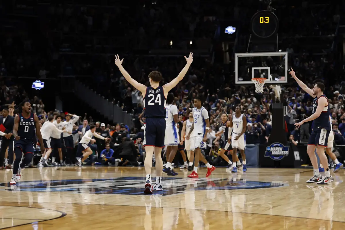 UConn Huskies guard Braylon Mullins (24) celebrates after making the game-winning three point field goal against the Duke Blue Devils in the final second of the game during an Elite Eight game of the East Regional of the men's 2026 NCAA Tournament at Capital One Arena.