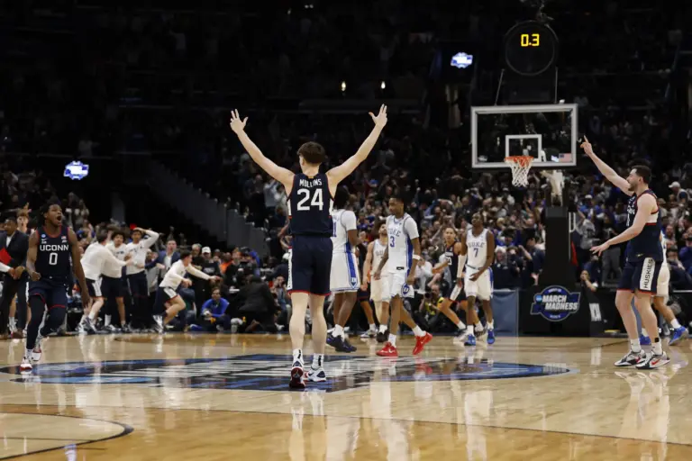 UConn Huskies guard Braylon Mullins (24) celebrates after making the game-winning three point field goal against the Duke Blue Devils in the final second of the game during an Elite Eight game of the East Regional of the men's 2026 NCAA Tournament at Capital One Arena.