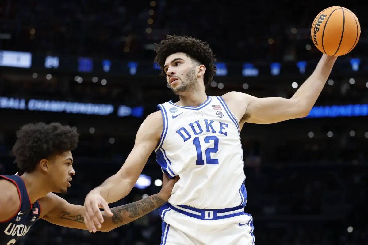 Duke Blue Devils forward Cameron Boozer (12) grabs the ball in front of UConn Huskies forward Jaylin Stewart (3) in the first half during an Elite Eight game of the East Regional of the men's 2026 NCAA Tournament at Capital One Arena.