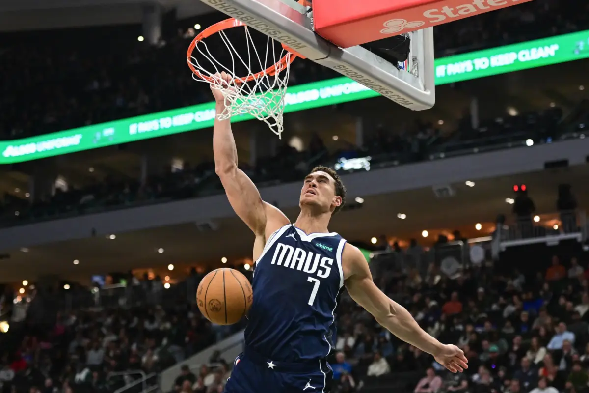 Mar 31, 2026; Milwaukee, Wisconsin, USA; Dallas Mavericks center Dwight Powell (7) dunks a basket in the fourth quarter against the Milwaukee Bucks at Fiserv Forum. Mandatory Credit: Benny Sieu-Imagn Images
