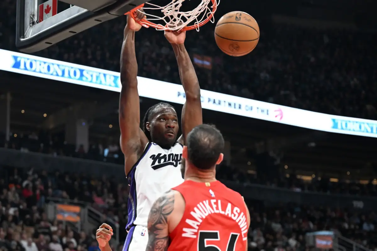Apr 1, 2026; Toronto, Ontario, CAN; Sacramento Kings forward Precious Achiuwa (9) dunks for a basket over Toronto Raptors center Sandro Mamukelashvili (54) in the first half at Scotiabank Arena. Mandatory Credit: Dan Hamilton-Imagn Images