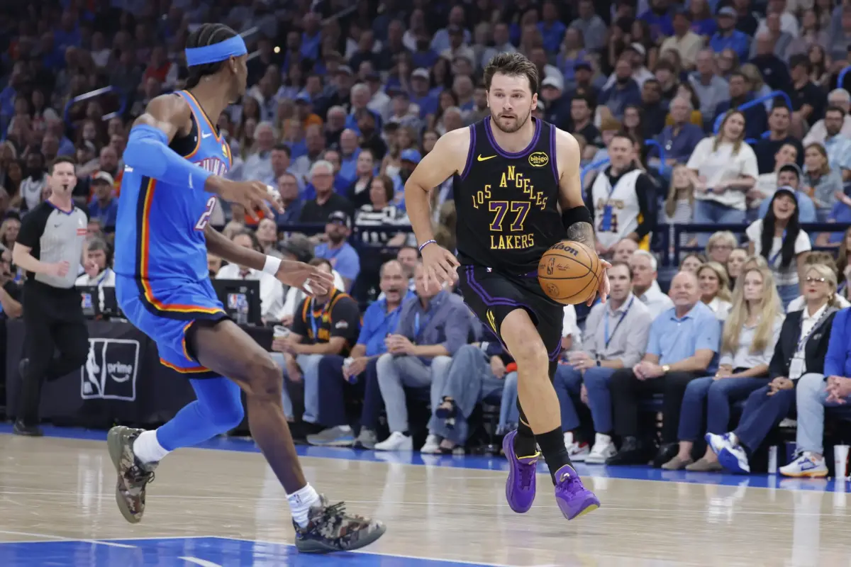 Apr 2, 2026; Oklahoma City, Oklahoma, USA; Los Angeles Lakers guard Luka Doncic (77) drives to the basket beside Oklahoma City Thunder guard Shai Gilgeous-Alexander (2) during the first quarter at Paycom Center. Mandatory Credit: Alonzo Adams-Imagn Images