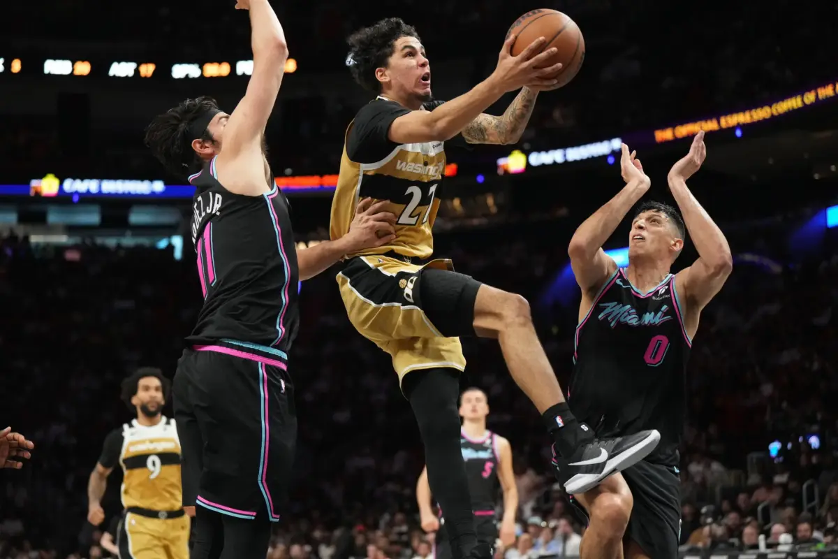 Washington Wizards guard Will Riley (27) drives to the basket as Miami Heat forward Simone Fontecchio (0) and forward Jaime Jaquez Jr. (11) defend during the second half at Kaseya Center.