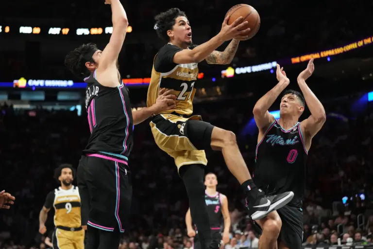 Washington Wizards guard Will Riley (27) drives to the basket as Miami Heat forward Simone Fontecchio (0) and forward Jaime Jaquez Jr. (11) defend during the second half at Kaseya Center.