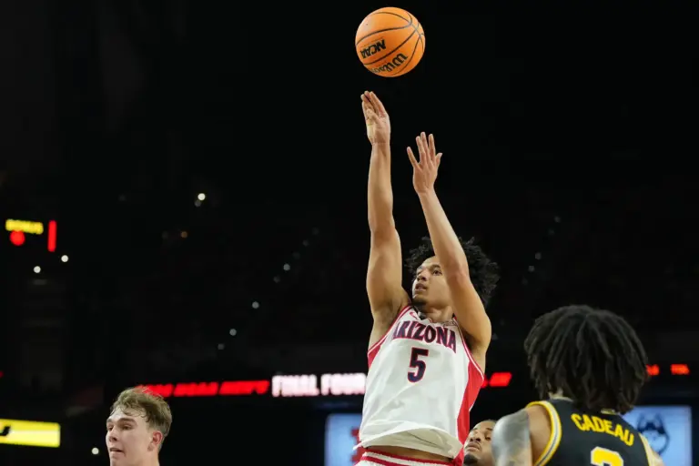 Arizona Wildcats guard Brayden Burries (5) shoots the ball against the Michigan Wolverines during the first half in a semifinal of the Final Four of the men's 2026 NCAA Tournament at Lucas Oil Stadium.
