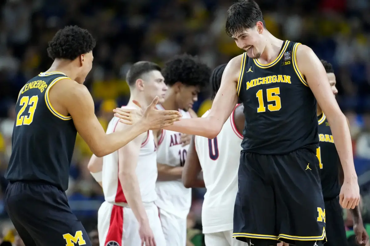Michigan Wolverines center Aday Mara (15) and forward Yaxel Lendeborg (23) celebrate a made basket Saturday, April 4, 2026, during a Final Four game against the Arizona Wildcats at Lucas Oil Stadium in Indianapolis.