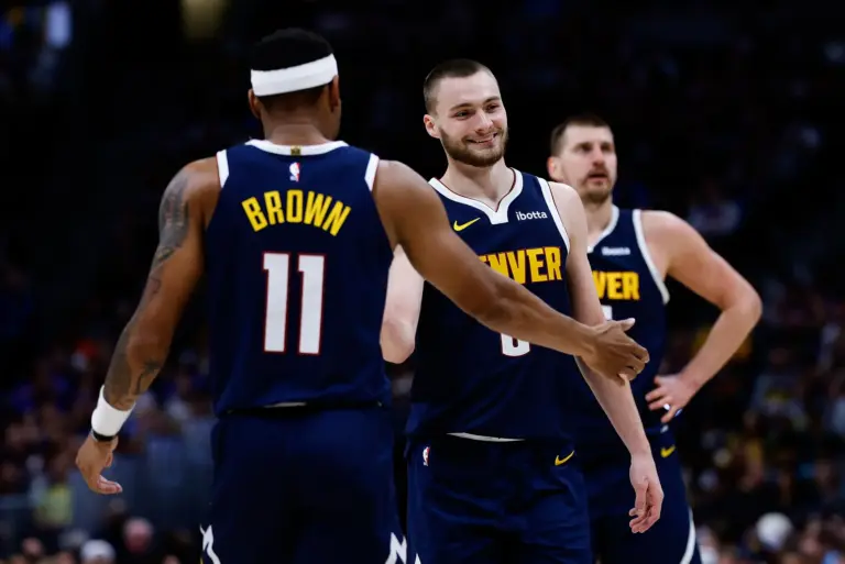 Denver Nuggets guard Christian Braun (0) and guard Bruce Brown (11) and center Nikola Jokic (15) in the second quarter against the Memphis Grizzlies at Ball Arena.