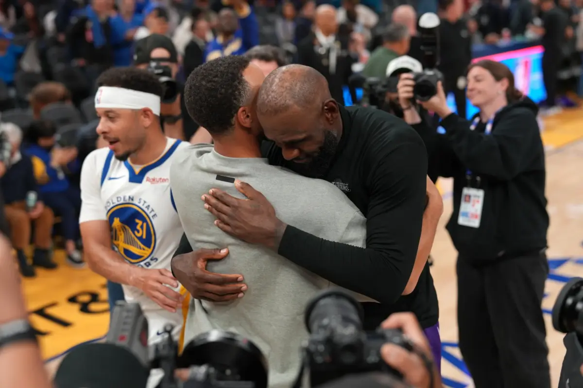 Los Angeles Lakers forward LeBron James (23) hugs Golden State Warriors guard Stephen Curry (30) after the game at the Chase Center.