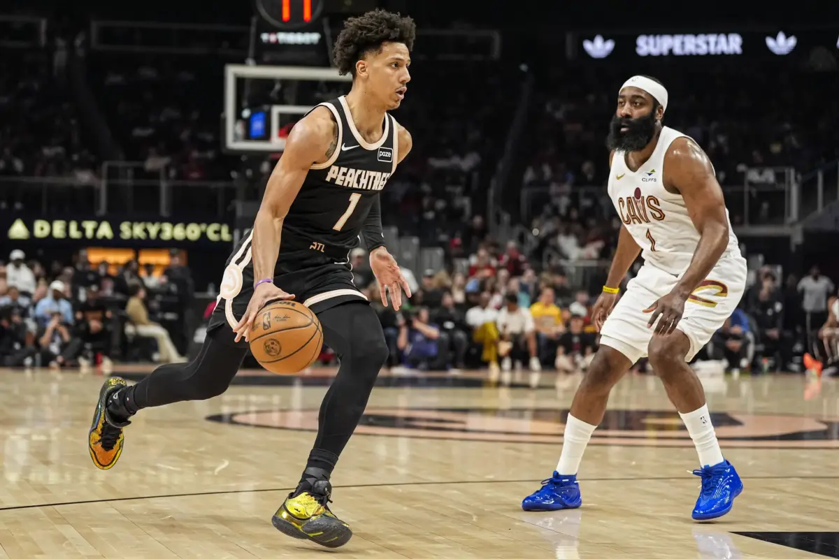 Atlanta Hawks forward Jalen Johnson (1) dribbles past Cleveland Cavaliers guard James Harden (1) during the first half at State Farm Arena.