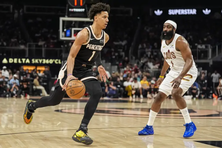 Atlanta Hawks forward Jalen Johnson (1) dribbles past Cleveland Cavaliers guard James Harden (1) during the first half at State Farm Arena.