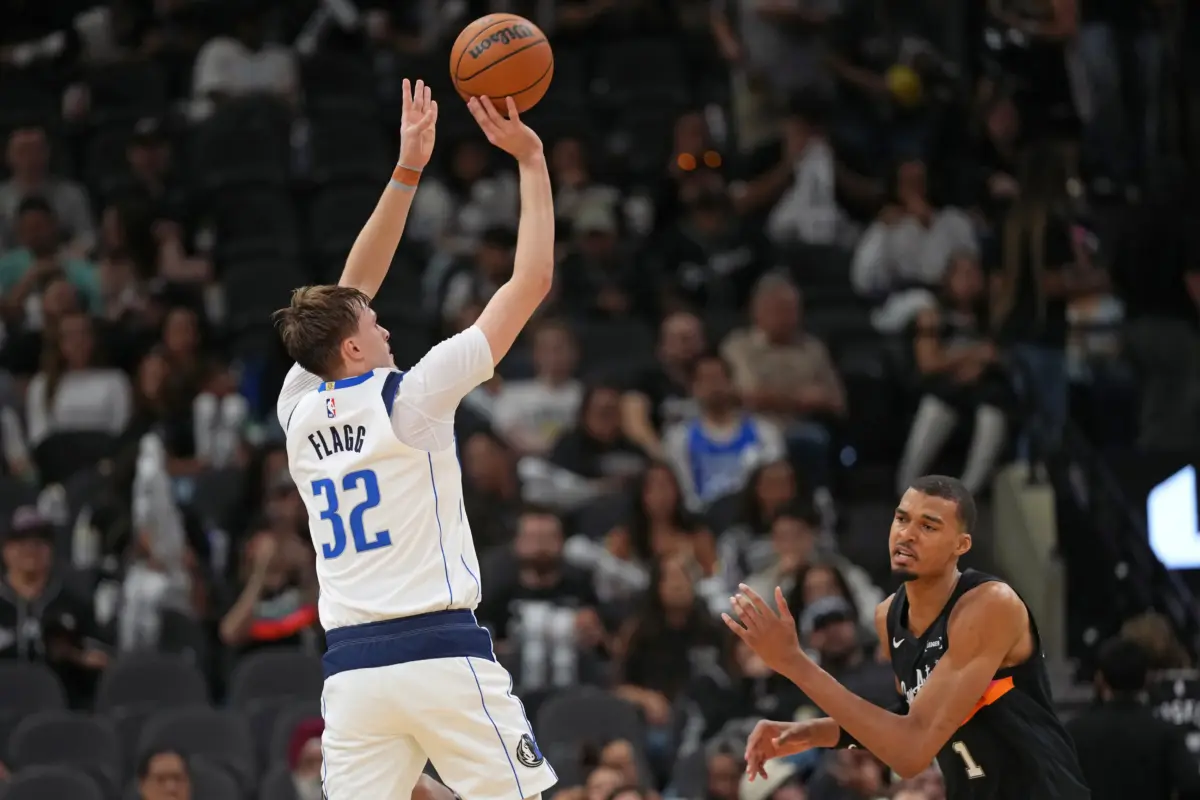 Dallas Mavericks forward Cooper Flagg (32) shoots over San Antonio Spurs forward Victor Wembanyama (1) during the second half at Frost Bank Center.