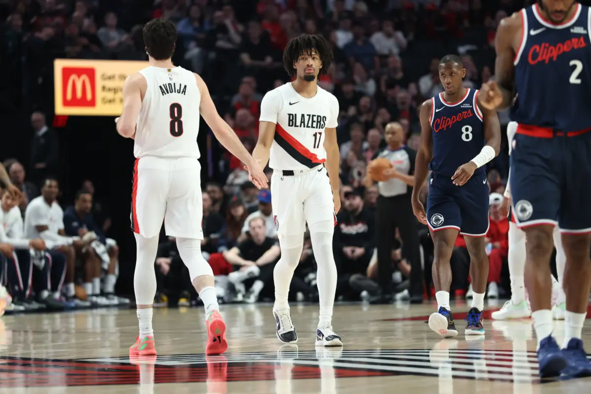 Portland Trail Blazers guard Shaedon Sharpe (17) is welcomed onto the court by teammate forward Deni Avdija (8) during the first half against the LA Clippers at Moda Center.