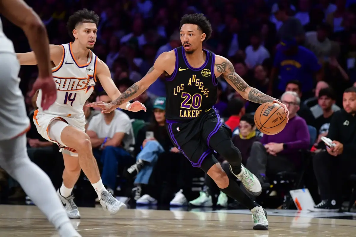 Apr 10, 2026; Los Angeles, California, USA; Los Angeles Lakers guard Nick Smith Jr. (20) moves the ball against Phoenix Suns guard Koby Brea (14) during the second half at Crypto.com Arena. Mandatory Credit: Gary A. Vasquez-Imagn Images